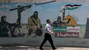 Palestyńczyk idzie obok graffiti przedstawiającego bojowników Hamasu strzelających rakietami, w mieście Chan Jounis w południowej Strefie Gazy, 30 maja 2022 r. Zdjęcie: Abed Rahim Khatib/Flash90.