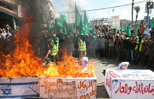 Członkowie Hamasu palą trumnę owiniętą izraelską flagą na wiecu z okazji 13. rocznicy drugiej intifady, 2013 (źródło: ABED RAHIM KHATIB/FLASH90)