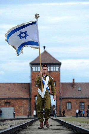 An Israeli soldier walking away from the gate in Auschwitz.