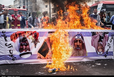 Palenie trumny pokrytej flag izraelsk z wizerunkami króla saudyjskiego, Salmana z kami wampira (Tasnim, Iran, 1 lipca 2016)