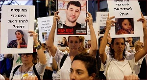 Izraelscy demonstranci trzymaj transparenty i plakaty z daniem zawarcia porozumienia w sprawie uwolnienia zakadników z Gazy.